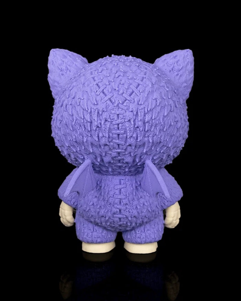 Back view of a purple bat-themed skull figurine with small wings on a black background