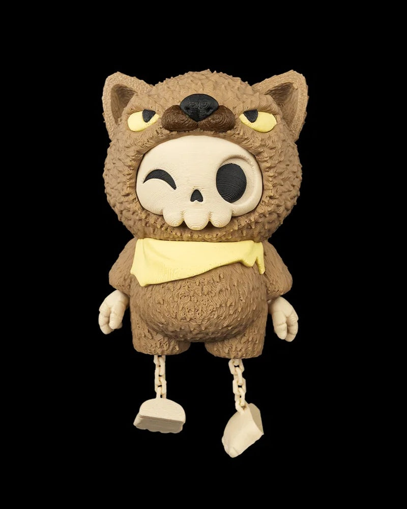 Front view of a brown animal-hood skull figurine with dangling legs on a black background