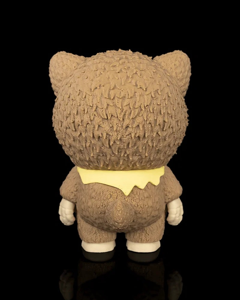 Back view of a brown animal-hood skull figurine with a yellow scarf on a black background