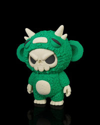 Angled front view of a green skull-faced monster toy with horns and white belly detail