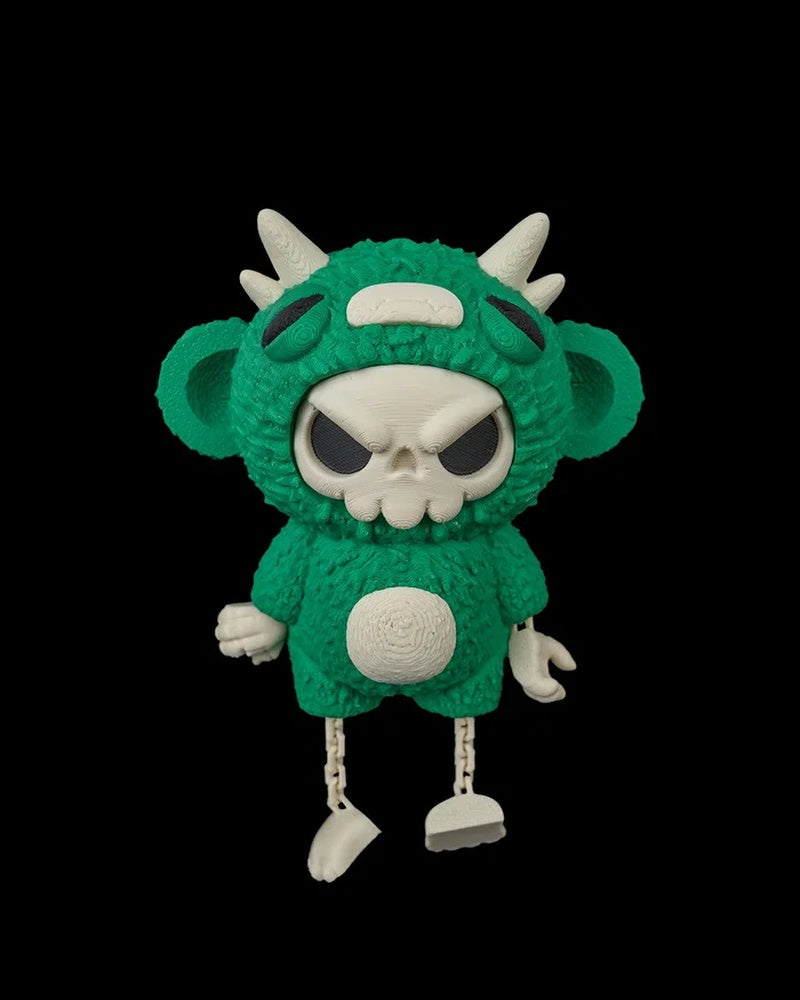 Front view of a green skull-faced monster toy with horns, ears, and white belly detail