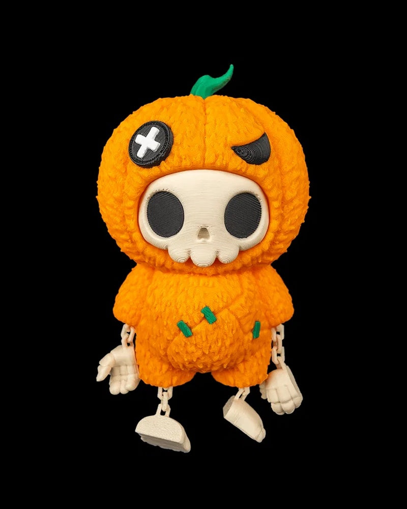 Orange pumpkin skull figure with dangling arms and legs on a black background