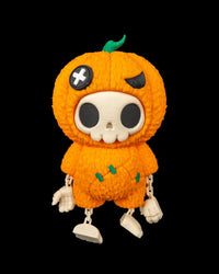 Orange pumpkin skull figure with dangling arms and legs on a black background