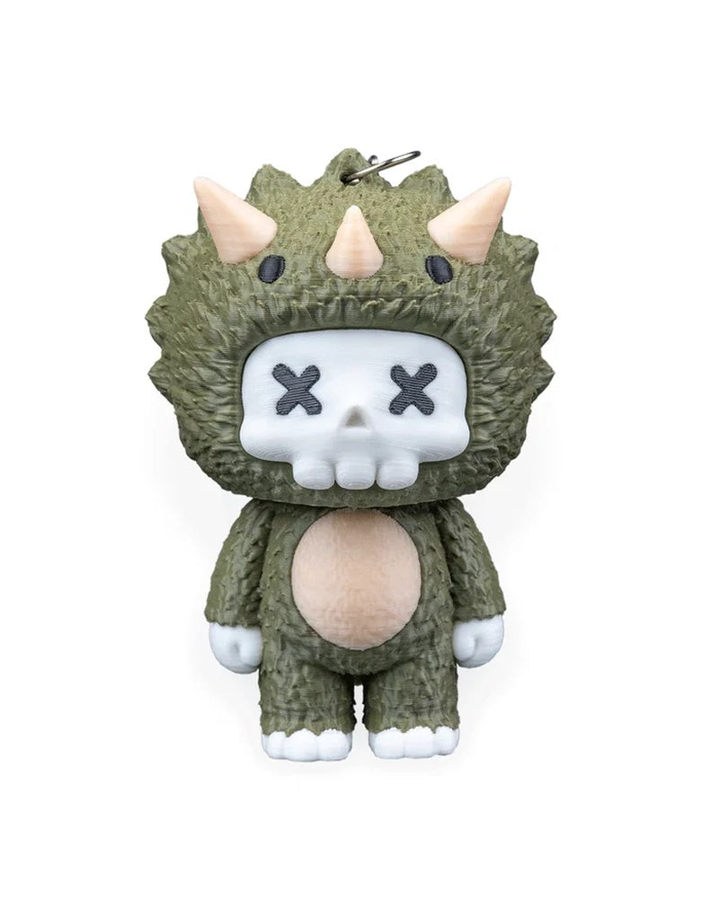 Front view of a green horned dinosaur character with a white skull face and X-shaped eyes.