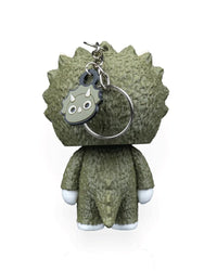 Back view of a green horned dinosaur character with a metal ring and small face charm.