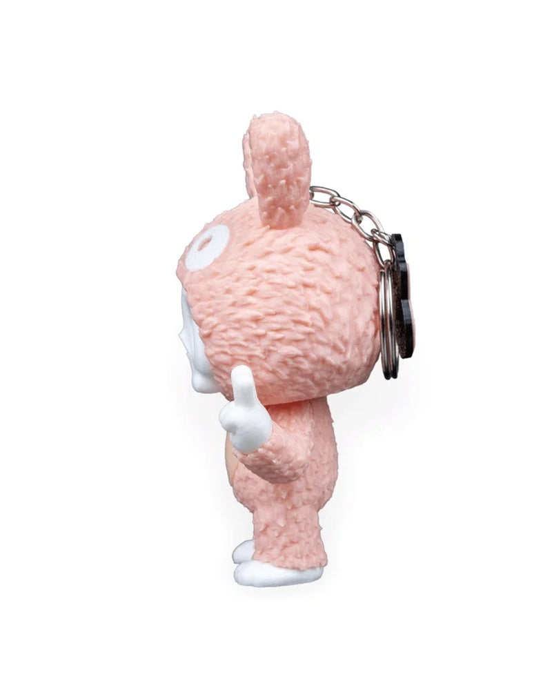 Side view of a pink bunny-suit skull character with chain and ring visible behind the head