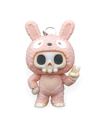 Front view of a pink bunny-suit skull character with tall ears, heart belly detail, and raised peace-sign hand