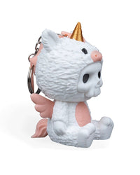Angled side view of a seated white unicorn costume figurine with a gold horn, pink belly, and pink tail