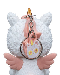 Close-up back view of a white unicorn costume figurine with pink wings and a metal ring and chain