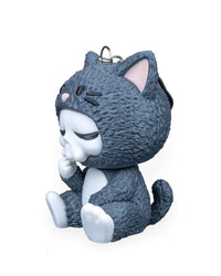 Side view of a seated gray cat costume character with textured gray fur and curled tail
