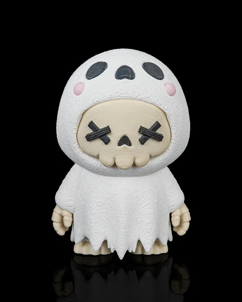 Front view of a white ghost skull figurine with black X eyes, pink cheeks, and a ragged robe on a black background.