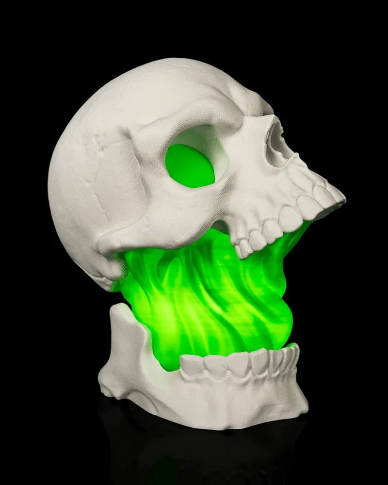 Side view of a white skull lamp with green illuminated interior
