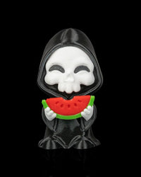 Hooded skull figurine holding a red and green watermelon slice on a black background