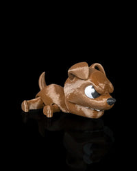Brown puppy snap toy with white eyes and black nose on a dark reflective surface