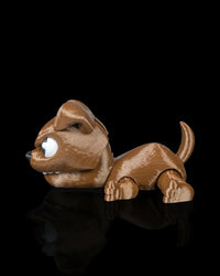 Side view of a brown puppy toy with white eyes, floppy ear, and raised tail