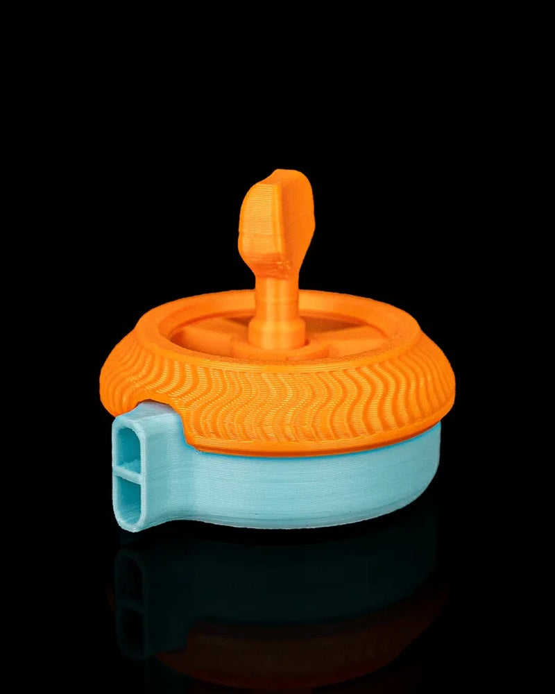 Side view of an orange and blue circular toy with a raised top grip and protruding opening on a black background