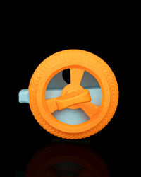 Top view of an orange circular wheel-like toy with a central handle and blue base visible below