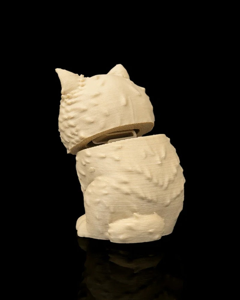 Rear angled view of a cream-colored cat figure with a tilted head and small tail on a black background