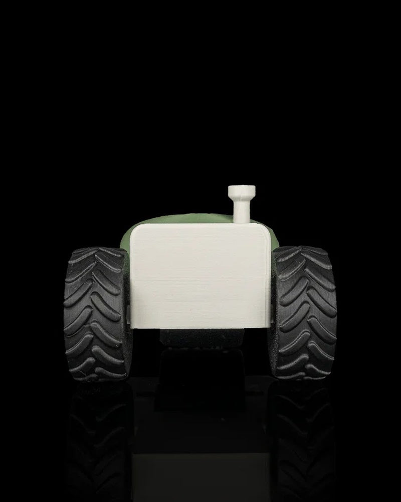 Rear view of the tractor-shaped tool showing two black treaded wheels and an off-white back panel.