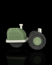 Side view of the tractor-shaped tool with a green body, off-white base, and black treaded wheel.