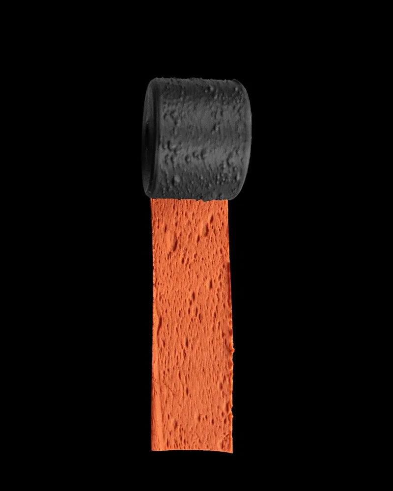 Black textured roller above an orange strip with a rough surface pattern.