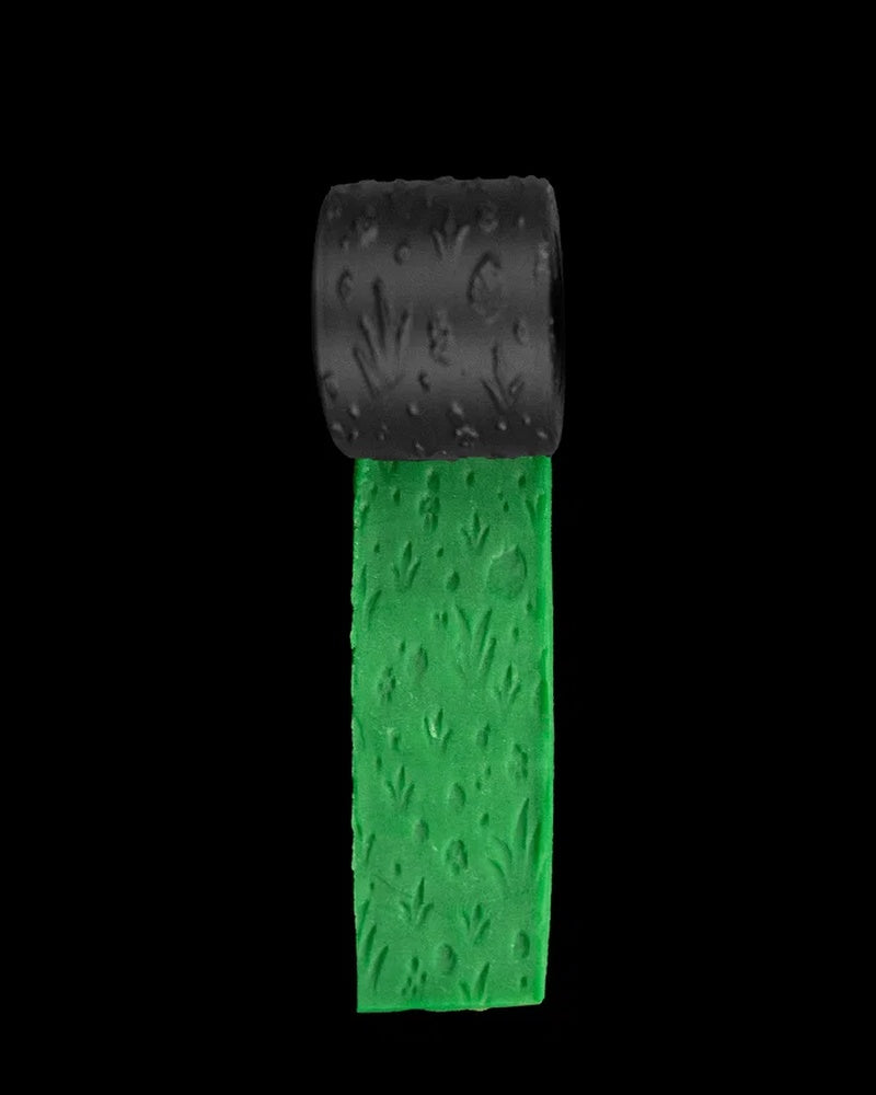 Black textured roller above a green strip with grass-like surface marks.