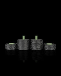Four black rollers displayed in a row, including treaded wheel shapes and textured cylindrical rollers.