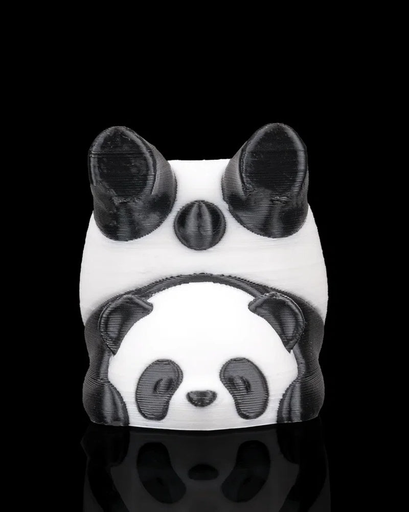 Front view of a black and white panda figurine with rounded ears and a smaller panda face detail