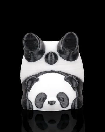 Front view of a black and white panda figurine with rounded ears and a smaller panda face detail