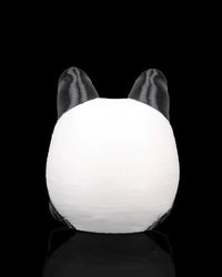 Back view of a rounded black and white panda figurine with two black ears