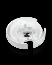 Open circular white base showing a small clear bulb and a black switch.