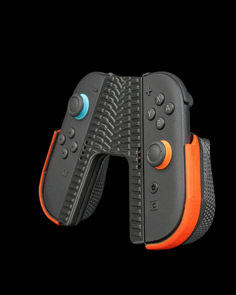 Angled front view of a black controller grip with orange side accents