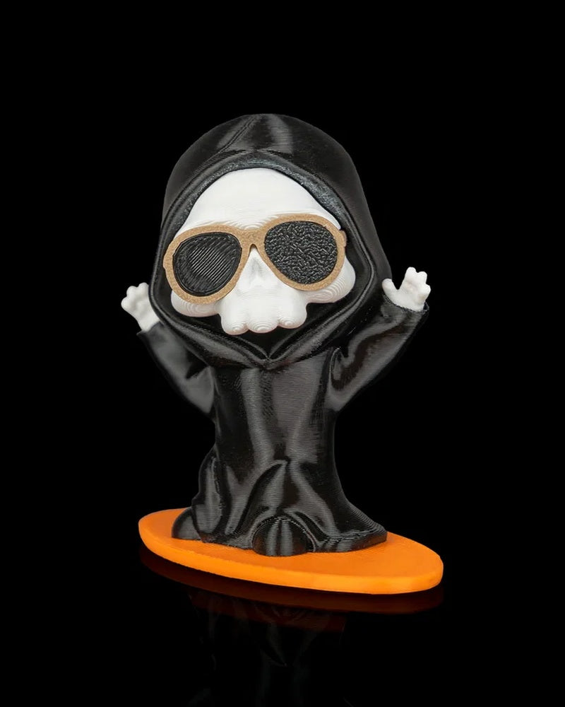 Ghost figurine wearing a black hooded robe and tan sunglasses on an orange board base