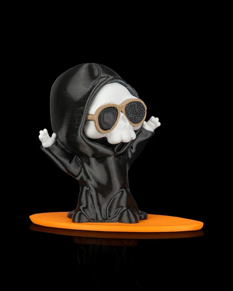 Ghost figurine with raised hands, sunglasses, and an orange board base on a black background