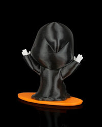 Back view of a black hooded ghost figurine with white hands on an orange base