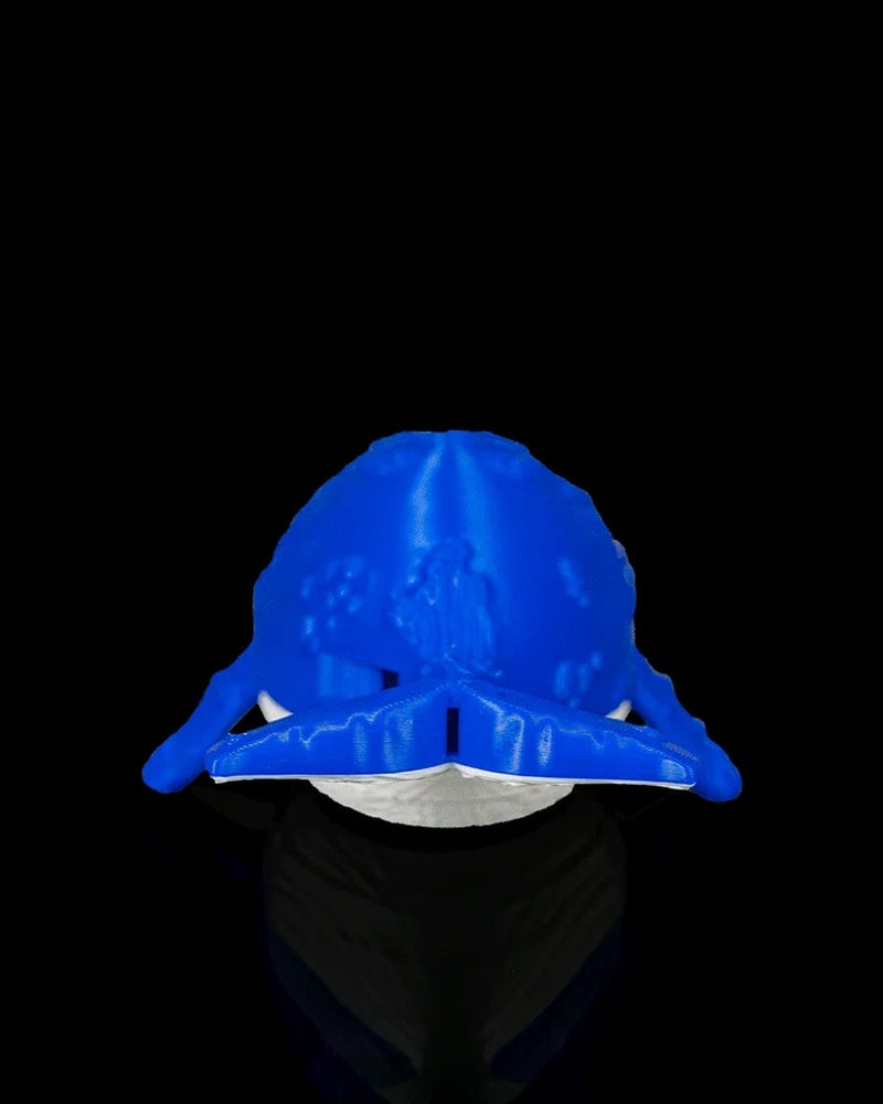 Rear view of a blue and white whale figurine with tail and flippers visible