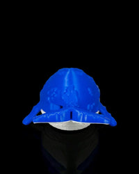 Rear view of a blue and white whale figurine with tail and flippers visible