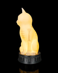 Side view of a glowing cat-shaped lamp showing internal skeletal-style markings